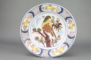 An 18th Century English polychrome Delft ware shallow bowl decorated with a bird in a tree with insect enclosed in a formal border 14"