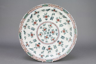 An 18th Century English polychrome Delft ware dish decorated with formal fields of flowers and scrolling border 14" 