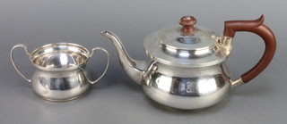 A silver bulbous teapot with fruitwood mounts and 2 handled sugar bowl Birmingham 1925/26 gross 362 grams 