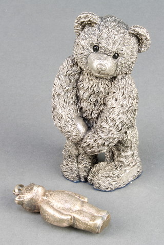 A silver filled figure of a standing bear 4", a ditto rattle 