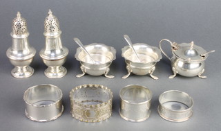 Edwardian silver peppers Birmingham 1905, a condiment set and 3 napkin rings, 230 grams 