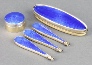 A silver mounted blue guilloche enamelled manicure set comprising nail buffer, patch box and 3 handles, BIrmingham 1928 