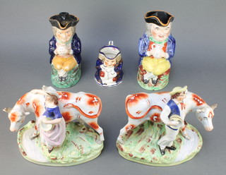 A pair of Victorian Staffordshire figures of a milkman and milkmaid, two 19th Century Toby jugs and a later ditto 
