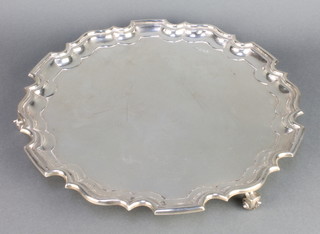 A silver salver with pie crust rim and scroll feet, Sheffield 1930 12", 890 grams
