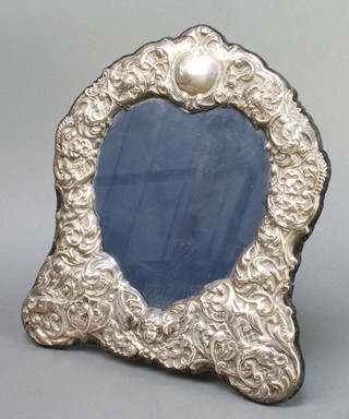 A Sterling silver repousse photograph frame decorated with cherubs, scrolls and mythical beasts 11" 