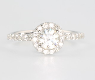 An 18ct white gold diamond cluster ring the centre stone 0.51ct surrounded by brilliant cut diamonds 0.35ct size M