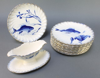 A German part service decorated with fish comprising a sauce boat and 12 dinner plates 