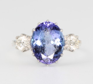 An 18ct white gold oval tanzanite and diamond ring, the centre stone approx 4.1ct, the 2 diamonds approx. 0.65ct size N 