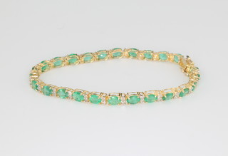 An 18ct yellow gold emerald and diamond bracelet, the diamonds approx. 0.75ct, the emeralds approx 8ct 