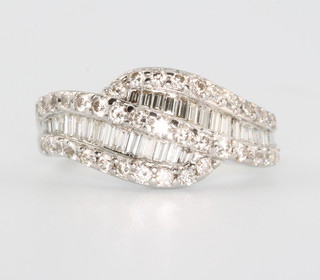 An 18ct white gold baguette and brilliant cut diamond ring size L