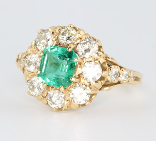 An 18ct yellow gold emerald and diamond Edwardian style cluster ring, the centre stone approx. 1.2ct surrounded by brilliant cut diamonds approx. 1.3ct size N 