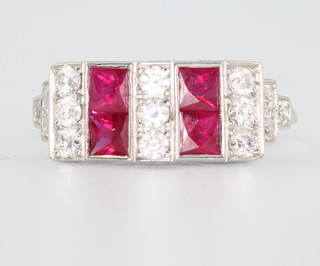An 18ct white gold ruby and diamond cocktail ring with 4 princess cut rubies and brilliant cut diamonds size O 1/2