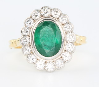 An 18ct yellow gold oval emerald and diamond cluster ring, the centre stone approx. 2.5ct surrounded by 16 brilliant cut diamonds approx 1.15ct size O 