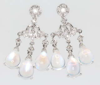 A pair of white gold diamond and moonstone ear drops 