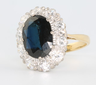 An 18ct yellow gold sapphire and diamond cluster ring size N 