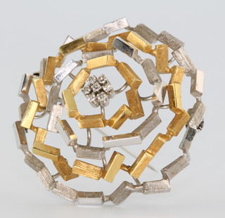 A stylish 18ct yellow and white brushed gold diamond set target brooch the centre with 7 brilliant cut diamonds 13.5 grams 