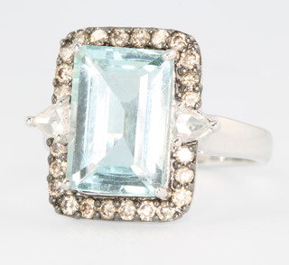 An 18ct white gold emerald cut aquamarine and diamond dress ring the centre stone approx 3.86ct, the brilliant and pear cut diamonds approx 0.63ct size M 1/2 
