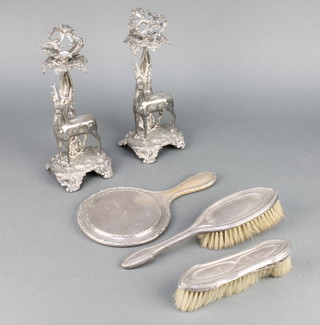 Two Victorian silver plated candlesticks with deer bases and a 3 piece silver brush set 