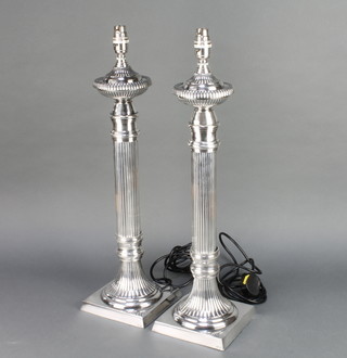 A pair of silver plated fluted table lamps on square bases 21" 