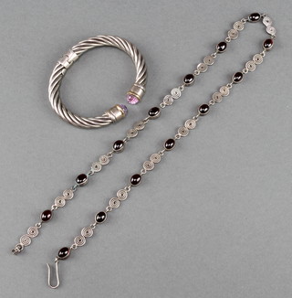 A silver and gold gem set expanding bangle together with a silver garnet necklace 