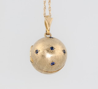 A 9ct yellow gold brushed gem set ball locket on a do. chain 6.2 grams 