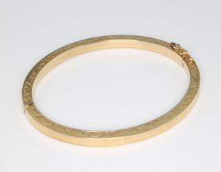 A 9ct yellow gold chased scroll bangle 13.8 grams 