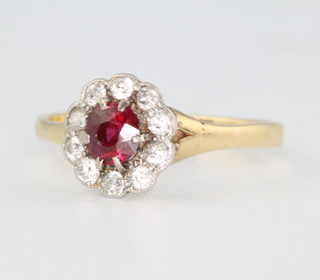 An 18ct yellow gold ruby and diamond cluster ring size L