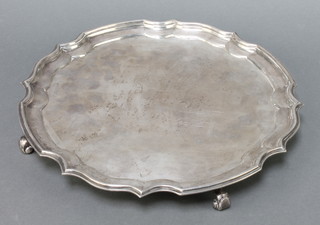 A silver salver with Chippendale rim on scroll feet London 1947, maker Garrard & Co 12", 30 ozs 