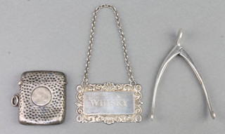 A pair of Edwardian novelty silver plated sugar tongs in the form of a wishbone, a silver vesta and a spirit label 