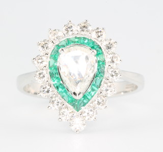 An 18ct white gold pear shaped emerald and diamond cluster ring, the centre pear cut diamond  approx. 0.56ct surrounded by emeralds approx. 0.64ct and brilliant cut diamonds approx. 0.66ct size O 