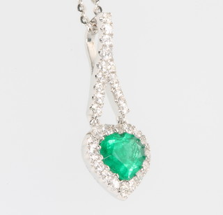An 18ct white gold emerald and diamond heart shaped pendant on a white 18ct gold chain 