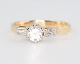 An 18ct yellow gold single stone diamond ring with baguette cut shoulders size I 1/2