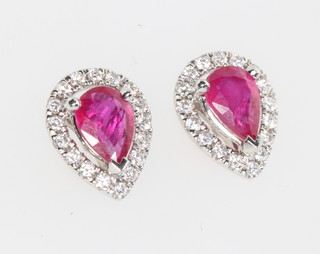 A pair of 18ct white gold pear cut ruby and diamond ear studs, the rubies approx. 1.19ct  the brilliant cut diamonds approx. 0.25ct 