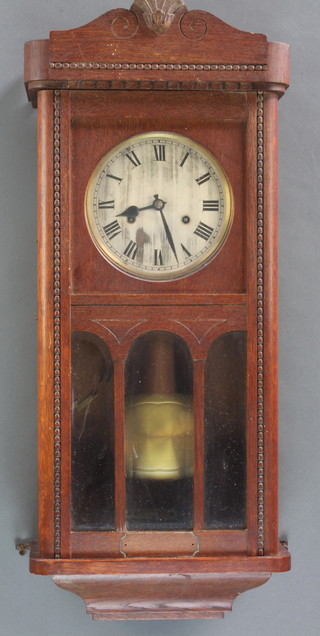A 1930's chiming wall clock with 7" silvered dial and Arabic numerals contained in an oak case 