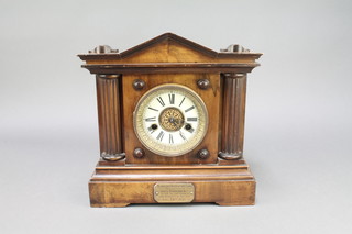 Hamburg American Clock Co., a 14 day striking mantel clock with enamelled dial and Arabic numerals contained in a walnut case with brass presentation plaque 