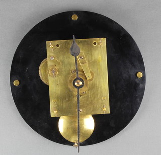A fusee clock movement with brass back plate 4 1/2" x 6" complete with hands and pendulum, raised on a circular black plastic plaque 