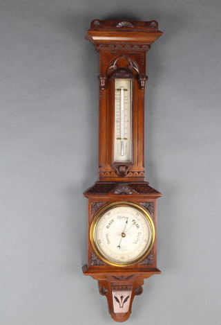 J Hicks of London, a Victorian aneroid barometer and thermometer contained in a carved walnut case with silvered dial marked J Hicks Makers London 9127 
