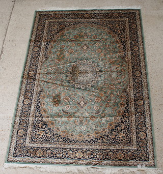 A green ground Belgian cotton Kashan style carpet with central medallion 89" x 63" 