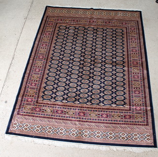 A blue and gold ground Belgian cotton Bokhara style rug with numerous octagons to the centre 109" x 79" 