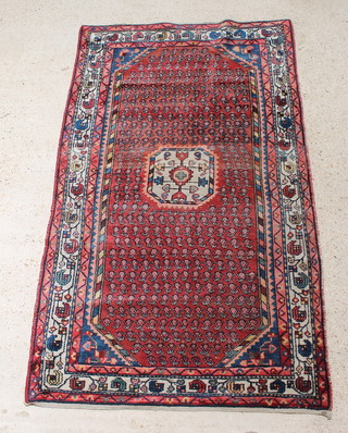 A Persian red and blue ground Malayer rug with octagon to the centre 79" x 47" 