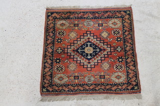 A Caucasian style rug with diamond shaped medallion to the centre decorated birds 47" x 47"