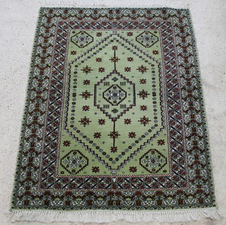 A green ground Moroccan wool rug with diamond medallion to the centre 75" x 62"