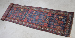 A blue and red ground Persian runner within multi-row border 214" x 43 1/2" 