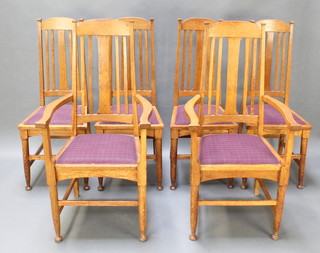 A set of 6 oak Art Nouveau Liberty style stick and rail back dining chairs, the seats raised on turned supports with box framed stretcher