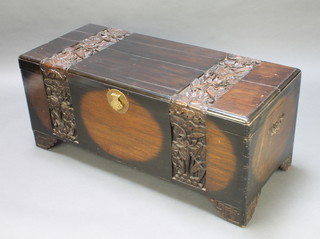 A Chinese carved camphor coffer with hinged lid and brass lock, raised on bracket feet, 20"h x 47"w x 21"d 