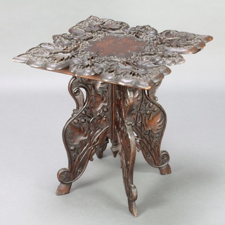 A Victorian deeply carved square hardwood table decorated leaves and berries, raised on a folding stand 23"h x 21"w x 21 1/2"d 