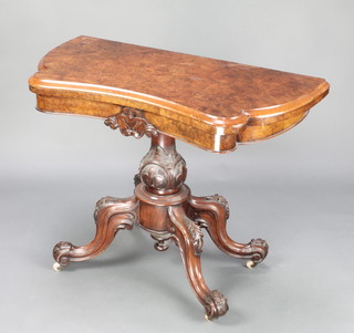A Victorian figured walnut tea table of serpentine outline, raised on a turned carved baluster and tripod base 27 1/2"h x 36"w x 18"d 