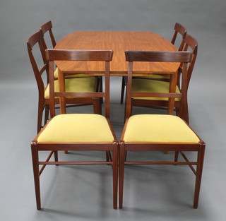 A mid 20th Century African hardwood dining suite comprising oval drop flap dining table with concealed leaves raised on turned supports 28"h x 40"w x 54"l together with 6 bar back chairs 
