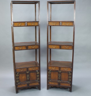 A pair of Chinese 3 tier rectangular hardwood what-nots fitted 6 short drawers above a pair of double cupboards enclosed by panelled doors 21 1/2" x 14" 