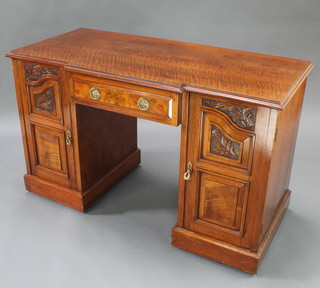 A Victorian mahogany breakfront dressing table/desk fitted 1 long drawer flanked by a pair of cupboards enclosed by panelled doors, raised on a platform base 29"h x 48"w x 22 1/2"w 